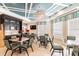 Comfortable lounge area with kitchenette, tables, and a TV, perfect for socializing and relaxing at 7207 Peregrina Loop, Wesley Chapel, FL 33545