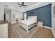 Spacious main bedroom with tray ceiling, neutral walls and natural light showcasing a beautiful bed at 7207 Peregrina Loop, Wesley Chapel, FL 33545
