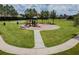 Inviting playground with slides, swings, and green space, ideal for Gathering fun and outdoor activities at 7207 Peregrina Loop, Wesley Chapel, FL 33545