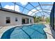 In-ground pool featuring a screened-in lanai, mature landscaping, and privacy at 7207 Peregrina Loop, Wesley Chapel, FL 33545