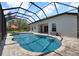 Backyard in-ground pool featuring a screened-in lanai and lush, mature landscaping at 7207 Peregrina Loop, Wesley Chapel, FL 33545