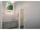 Vanity area with light grey cabinets and drawers with a large arched window above at 740 Crystal Dr, Palm Harbor, FL 34683