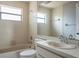 Bright bathroom with a large mirror, vanity sink, white tile, and a tub with shower at 740 Crystal Dr, Palm Harbor, FL 34683