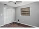 Bedroom featuring a closet with white louvered doors, a window, grey walls, and laminate floors at 740 Crystal Dr, Palm Harbor, FL 34683