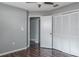 Bedroom with hardwood floors and a ceiling fan, showing the closet and doorway to another room at 740 Crystal Dr, Palm Harbor, FL 34683