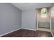 View of bedroom with a peek into the bathroom with a vanity and a white arched window at 740 Crystal Dr, Palm Harbor, FL 34683
