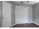 This bedroom features hardwood floors, a large closet, and a doorway to another room at 740 Crystal Dr, Palm Harbor, FL 34683