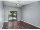 Large bedroom with wood floors, ceiling fan and sliding door to pool area at 740 Crystal Dr, Palm Harbor, FL 34683