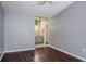 View of the bedroom with grey walls, brown laminate floors, and a bathroom attached at 740 Crystal Dr, Palm Harbor, FL 34683