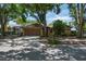 Charming single-story home with a well-maintained front yard and mature shade trees at 740 Crystal Dr, Palm Harbor, FL 34683