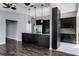 This modern kitchen features black cabinetry, stainless steel appliances, and pendant lighting at 740 Crystal Dr, Palm Harbor, FL 34683