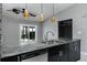 Kitchen island with stainless steel dishwasher, faucet and lighting at 740 Crystal Dr, Palm Harbor, FL 34683