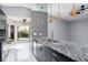Kitchen island with granite countertop and mosaic tile detail at 740 Crystal Dr, Palm Harbor, FL 34683