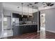 Modern kitchen features black cabinetry, granite countertops, stainless appliances, and pendant lighting at 740 Crystal Dr, Palm Harbor, FL 34683