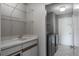 Laundry room featuring white countertop, a utility sink, wire shelves, and a modern washer and dryer at 740 Crystal Dr, Palm Harbor, FL 34683