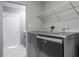 Modern laundry room equipped with high-end appliances, overhead storage, and neutral colors at 740 Crystal Dr, Palm Harbor, FL 34683