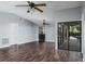 Spacious living room with hard floors, sliding glass doors to the outdoor space, and ceiling fans at 740 Crystal Dr, Palm Harbor, FL 34683