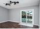 A simple living room featuring wood floors and glass sliding doors leading to the pool at 740 Crystal Dr, Palm Harbor, FL 34683
