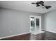 Living room featuring wood floors and glass sliding doors at 740 Crystal Dr, Palm Harbor, FL 34683