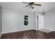 Bright living room with modern flooring, a ceiling fan, and a large window at 740 Crystal Dr, Palm Harbor, FL 34683