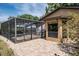 The rear patio leads to an enclosed pool area with brick pavers at 740 Crystal Dr, Palm Harbor, FL 34683