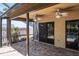 Covered patio featuring brick flooring, ceiling fans, and views of the yard and nearby sparkling swimming pool at 740 Crystal Dr, Palm Harbor, FL 34683