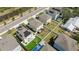 An aerial view of a well manicured neighborhood with manicured lawns, solar panels, and backyard patios at 7509 S Sherrill St, Tampa, FL 33616