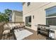 Outdoor deck area with comfortable seating, table, grill and access to the interior at 7509 S Sherrill St, Tampa, FL 33616