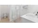 Bright bathroom featuring double sinks, and a glass-enclosed shower at 7509 S Sherrill St, Tampa, FL 33616