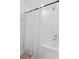 Full bathtub with white subway tile surround and shower curtain at 7509 S Sherrill St, Tampa, FL 33616