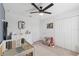 Bedroom featuring a crib, changing table and a cozy sitting area at 7509 S Sherrill St, Tampa, FL 33616