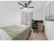Well-lit bedroom with ceiling fan, carpet and a dedicated desk with monitor setup at 7509 S Sherrill St, Tampa, FL 33616