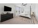 Bright bedroom with a four-post bed, large windows, ceiling fan, and a dark dresser at 7509 S Sherrill St, Tampa, FL 33616