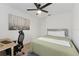Bedroom with a ceiling fan, a desk setup with a keyboard and artwork on the wall at 7509 S Sherrill St, Tampa, FL 33616