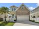 Home exterior featuring stone accents and a two-car garage at 7509 S Sherrill St, Tampa, FL 33616