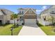 Charming two-story home with stone accents, manicured lawn, and a welcoming entrance at 7509 S Sherrill St, Tampa, FL 33616