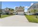 Suburban home with wide driveway, stone facade and palm tree in the front yard at 7509 S Sherrill St, Tampa, FL 33616