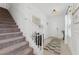 Bright foyer featuring stairs, mirror, and hardwood floors at 7509 S Sherrill St, Tampa, FL 33616