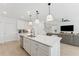 Open concept kitchen with a quartz countertop island and stainless steel appliances at 7509 S Sherrill St, Tampa, FL 33616