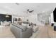 Bright and airy living room featuring hardwood floors, a modern ceiling fan, and an open layout at 7509 S Sherrill St, Tampa, FL 33616