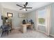 Well lit home office offers a large desk, stylish furniture and carpeted floor at 7509 S Sherrill St, Tampa, FL 33616