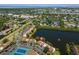 Overhead view of home, tennis courts, a parking lot and lake at 782 Village Lake N Ter # 102, St Petersburg, FL 33716