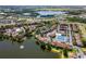 An aerial view of a lakeside community featuring mature trees, ample parking, tennis courts, and a shared pool at 782 Village Lake N Ter # 102, St Petersburg, FL 33716