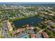 Aerial view of the community around a tranquil lake at 782 Village Lake N Ter # 102, St Petersburg, FL 33716