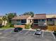 Exterior of home featuring reserved parking spaces and tropical landscaping at 782 Village Lake N Ter # 102, St Petersburg, FL 33716