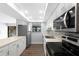 Modern kitchen boasts stainless steel appliances, white cabinets and a view of the lake at 782 Village Lake N Ter # 102, St Petersburg, FL 33716