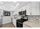 Modern kitchen featuring stainless steel appliances and a stylish backsplash at 782 Village Lake N Ter # 102, St Petersburg, FL 33716