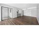 Open-concept living space featuring modern wood floors and a view of the updated kitchen at 782 Village Lake N Ter # 102, St Petersburg, FL 33716