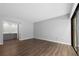 Bright living room featuring sleek wood floors, neutral walls, and sliding glass doors to a balcony at 782 Village Lake N Ter # 102, St Petersburg, FL 33716
