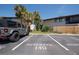 Reserved parking spot in a condo community near tropical landscaping and well-maintained lawns at 782 Village Lake N Ter # 102, St Petersburg, FL 33716